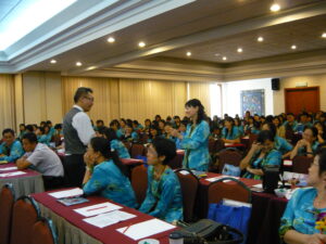 Dr. Hooi conducting a training session with a group of teachers